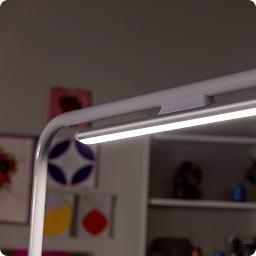 Quilter using a large frame with Finesse Aura overhead lighting