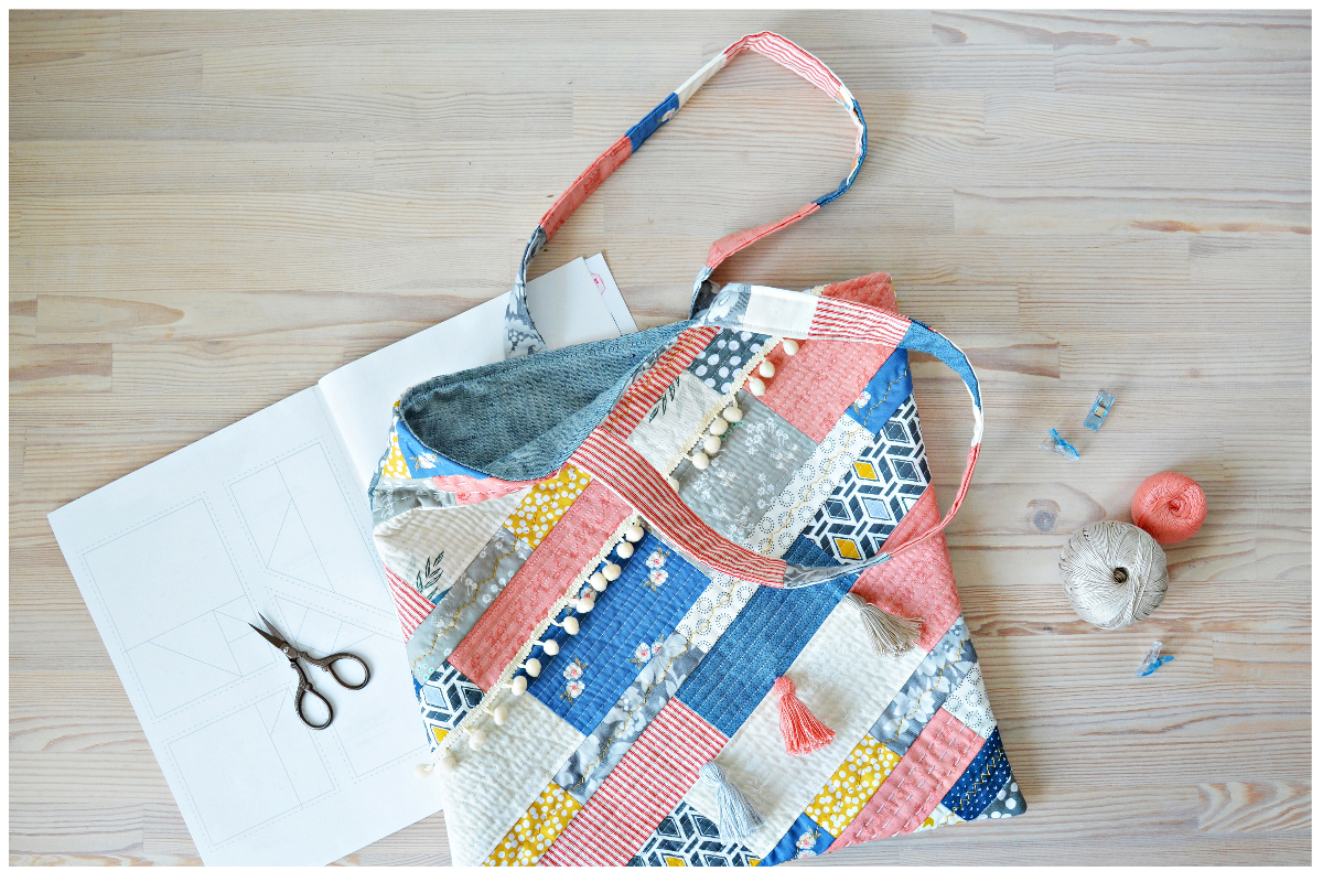 A patchwork bag on a table

Description automatically generated
