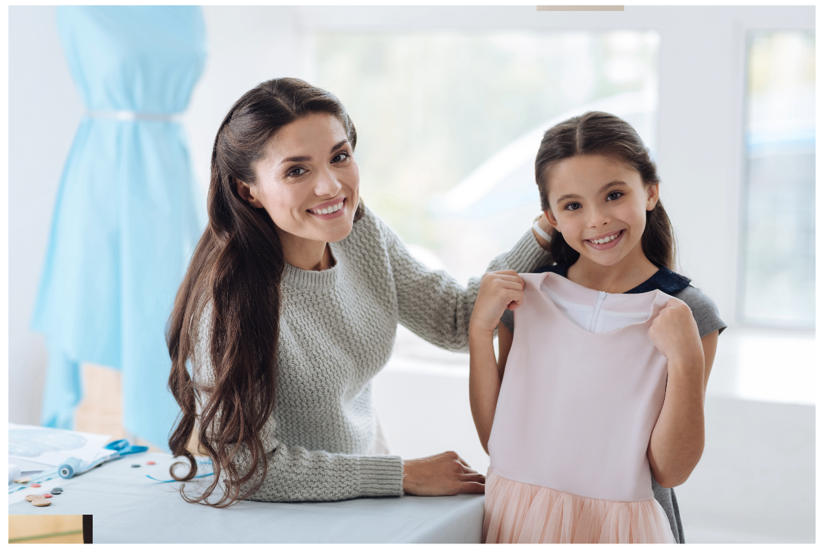A person and a child holding a dress

Description automatically generated