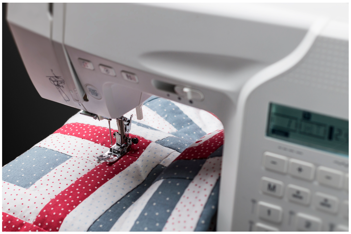 A sewing machine with a red white and blue fabric
Description automatically generated