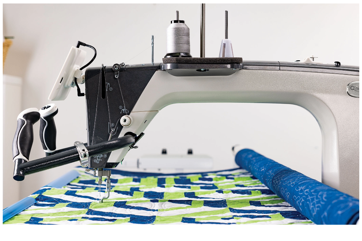 A sewing machine with a roll of fabric
Description automatically generated